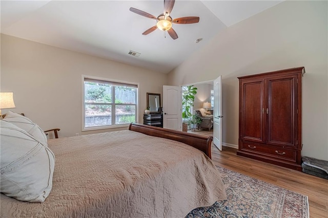 bedroom featuring lofted ceiling, wood finished floors, and ceiling fan