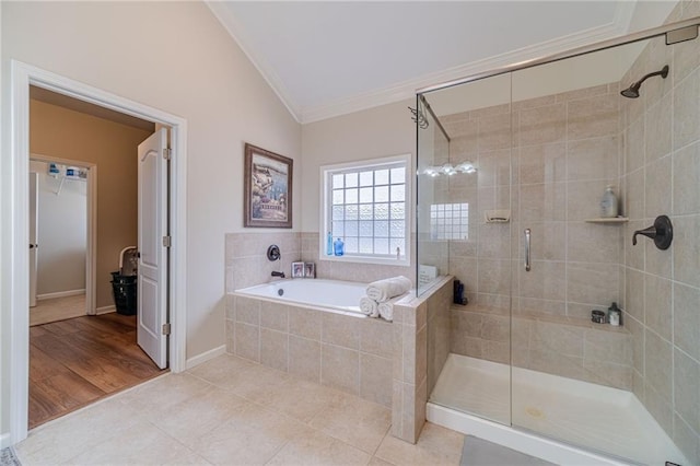 full bath with crown molding, a shower stall, a bath, tile patterned flooring, and lofted ceiling
