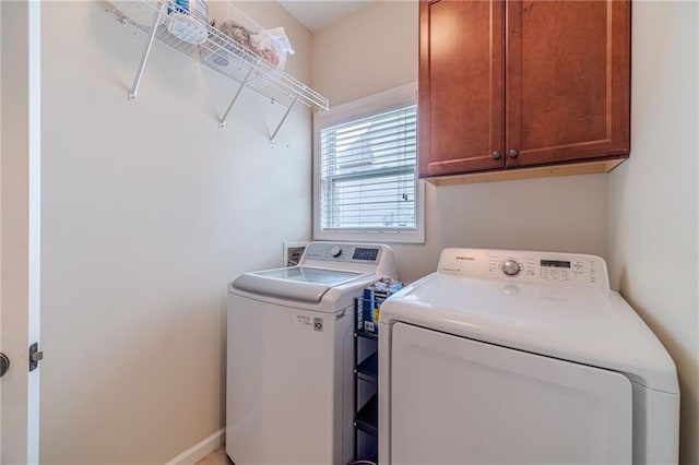 washroom with washing machine and dryer and cabinet space