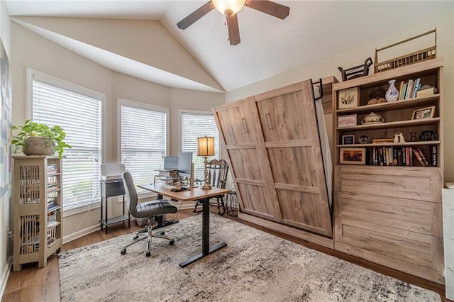 office space featuring ceiling fan, vaulted ceiling, and wood finished floors