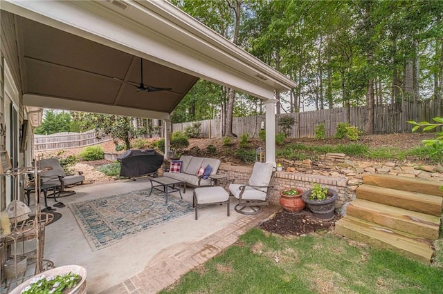 view of patio featuring an outdoor hangout area, a ceiling fan, grilling area, and a fenced backyard