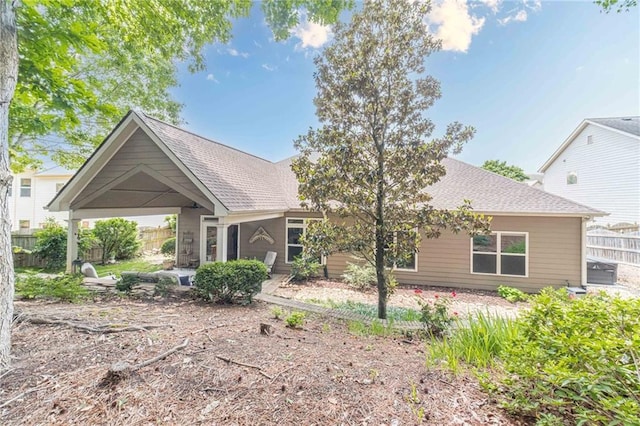view of front of property with fence and a shingled roof