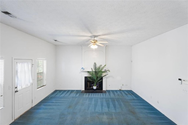 interior space featuring ceiling fan and a textured ceiling