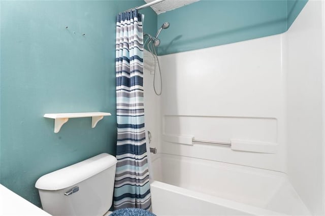 bathroom with a textured ceiling, shower / tub combo, and toilet