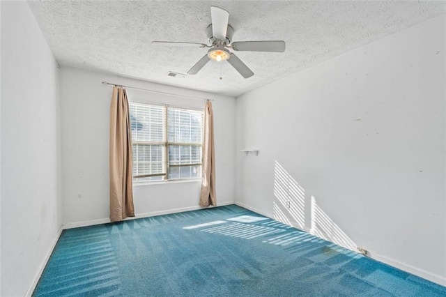 empty room featuring carpet flooring, a textured ceiling, and ceiling fan