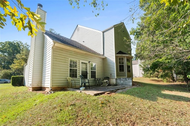 back of house featuring a yard and a patio