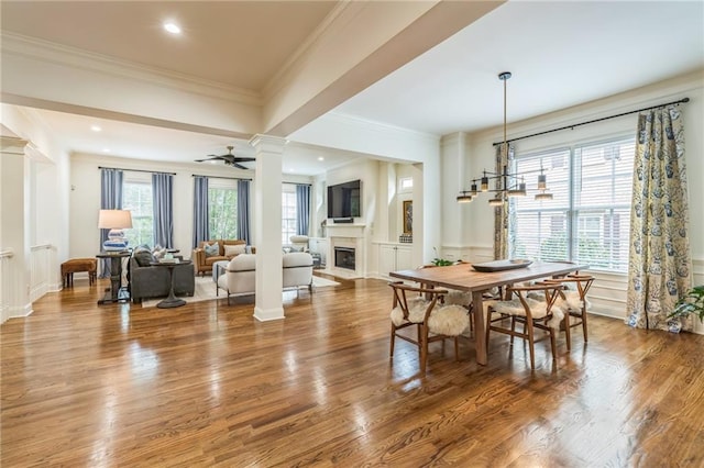 2313 Saint Davids Sq NW Unit 12, Kennesaw, GA 30152 - dining area with ornate columns, a fireplace, wainscoting, wood finished floors, and a decorative wall