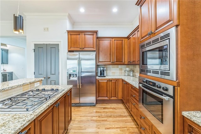 2313 Saint Davids Sq NW Unit 12, Kennesaw, GA 30152 - kitchen featuring stainless steel appliances, light wood finished floors, decorative backsplash, light stone countertops, and crown molding