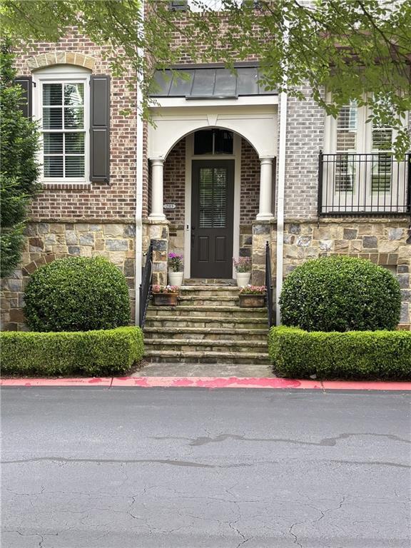 2313 Saint Davids Sq NW Unit 12, Kennesaw, GA 30152 - doorway to property featuring stone siding and brick siding