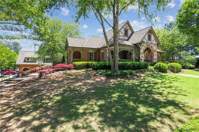 2313 Saint Davids Sq NW Unit 12, Kennesaw, GA 30152 - english style home featuring a front yard, brick siding, and stone siding