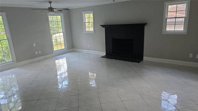 unfurnished living room featuring a ceiling fan, a fireplace with flush hearth, baseboards, and light tile patterned floors