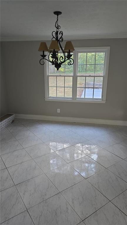 unfurnished dining area with a chandelier, crown molding, and baseboards