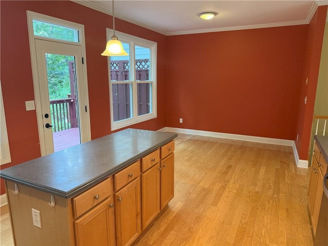 2895 Brandl Cove Ct Unit 4, Marietta, GA 30067 - kitchen with dark countertops, light wood-style flooring, crown molding, and a center island