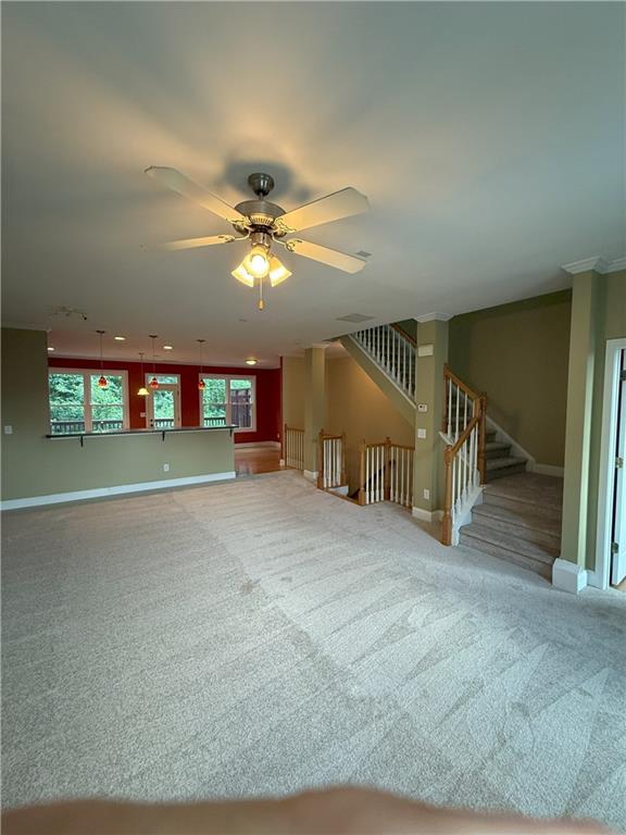 2895 Brandl Cove Ct Unit 4, Marietta, GA 30067 - unfurnished living room with carpet flooring, a ceiling fan, and stairs