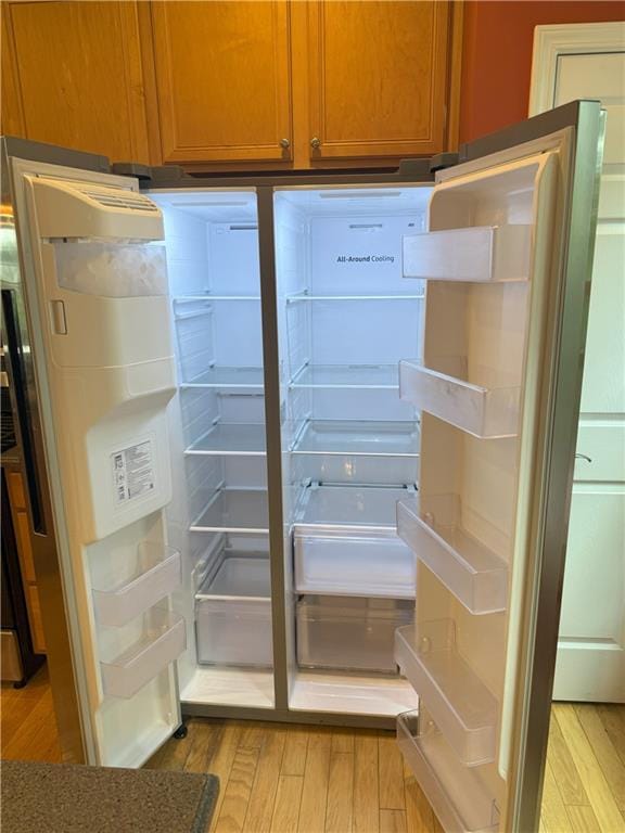2895 Brandl Cove Ct Unit 4, Marietta, GA 30067 - detailed view of light wood-type flooring, brown cabinetry, and fridge