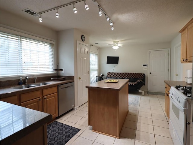 550 Sessingham Ct, Alpharetta, GA 30005 - kitchen featuring white range with gas stovetop, stainless steel dishwasher, ceiling fan, a center island, and rail lighting