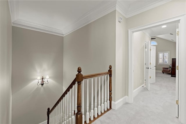 hallway with carpet, baseboards, crown molding, and an upstairs landing