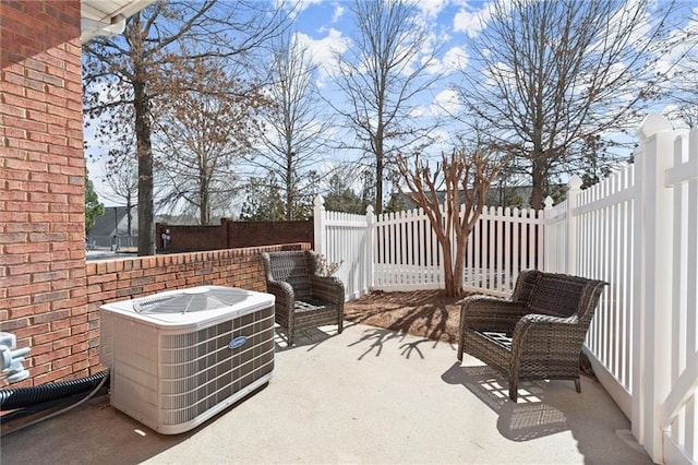 view of patio / terrace featuring a fenced backyard and central air condition unit