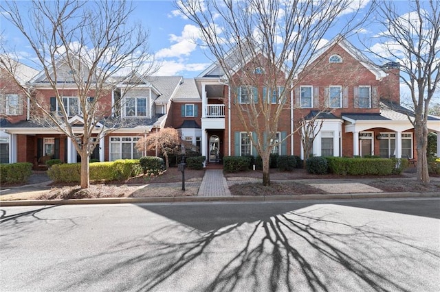 view of front of home featuring a residential view and brick siding