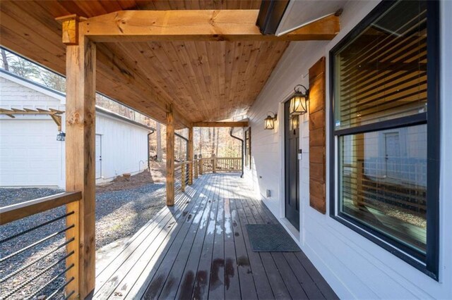 wooden terrace with a porch and a garage