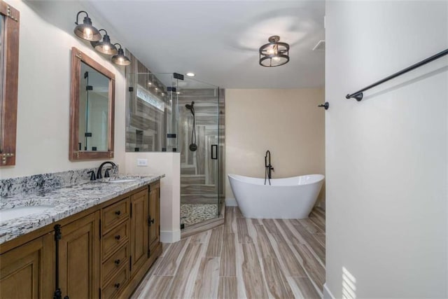 bathroom featuring hardwood / wood-style flooring, vanity, and independent shower and bath