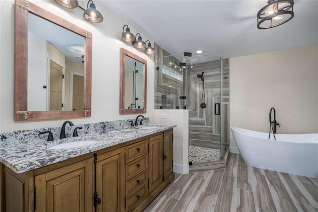 bathroom featuring vanity and separate shower and tub