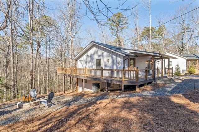 exterior space with an outdoor fire pit and a deck