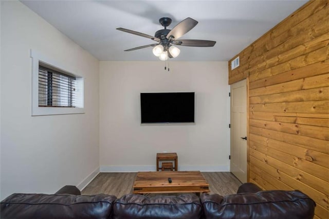 living room featuring wood-type flooring and ceiling fan