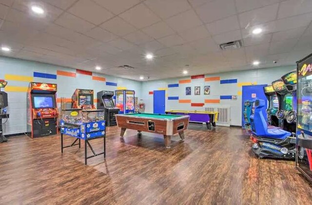 game room with pool table, dark wood-type flooring, and a paneled ceiling