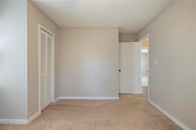 unfurnished bedroom featuring carpet floors, a closet, and baseboards