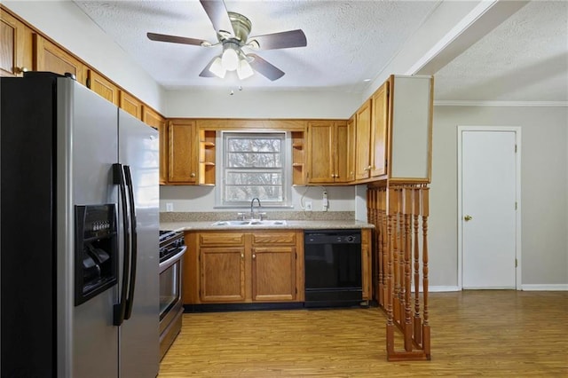 kitchen featuring appliances with stainless steel finishes, a sink, light wood finished floors, and open shelves