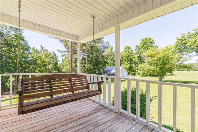 wooden deck featuring a lawn