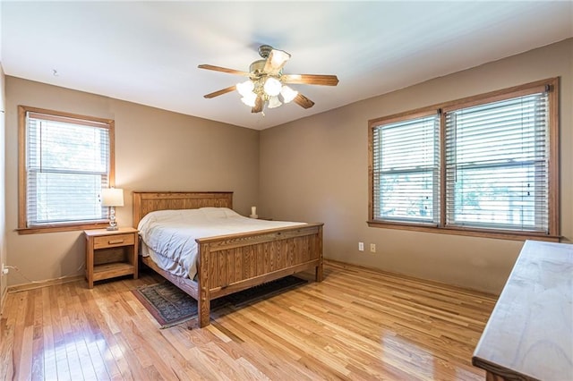 bedroom featuring light wood-style flooring and ceiling fan