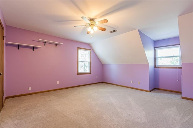 bonus room featuring light carpet, plenty of natural light, and visible vents