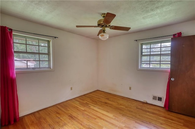 1342 Peggy Ln NW, Conyers, GA 30012 - unfurnished room with wood finished floors, a textured ceiling, and ceiling fan