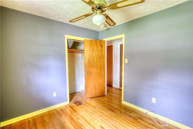 1342 Peggy Ln NW, Conyers, GA 30012 - unfurnished bedroom featuring wood finished floors, a closet, and a ceiling fan