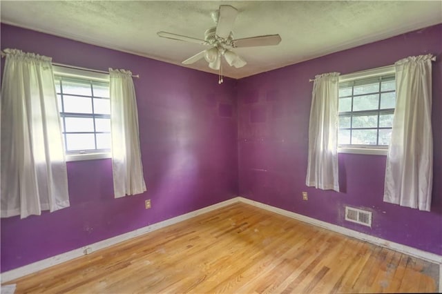 1342 Peggy Ln NW, Conyers, GA 30012 - spare room with plenty of natural light, wood finished floors, ceiling fan, and a textured ceiling