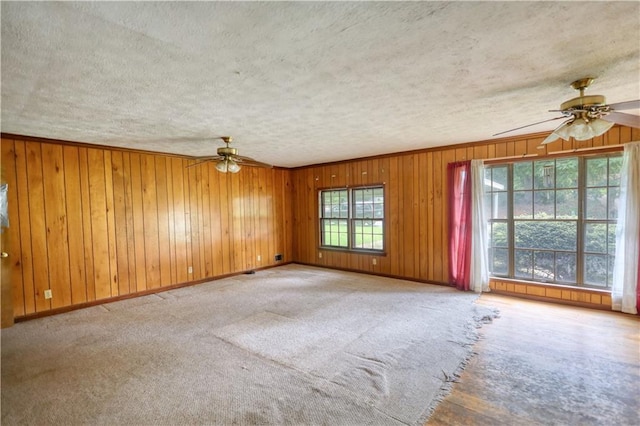 1342 Peggy Ln NW, Conyers, GA 30012 - unfurnished room featuring ceiling fan, a textured ceiling, carpet floors, and wood walls