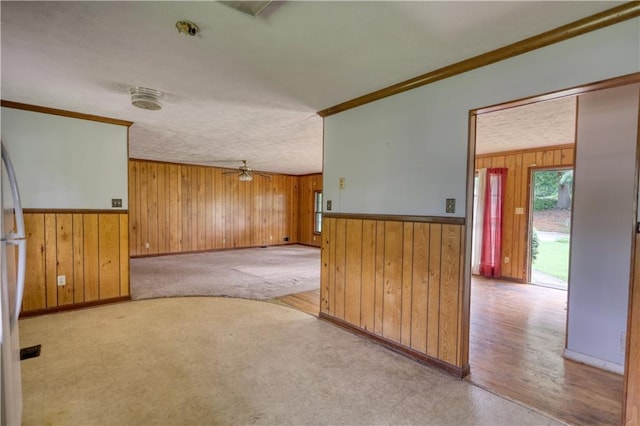 1342 Peggy Ln NW, Conyers, GA 30012 - spare room with wood walls, crown molding, ceiling fan, and wainscoting