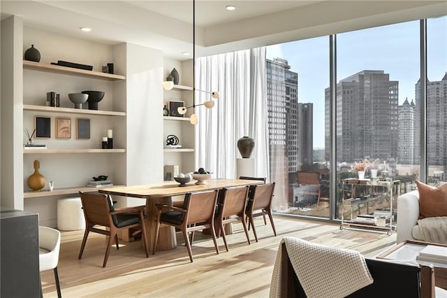 dining area featuring built in features and light hardwood / wood-style flooring