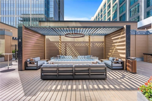 deck featuring a pergola and outdoor lounge area