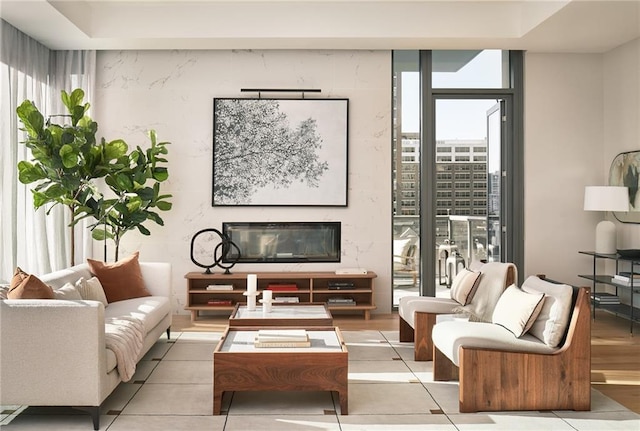 tiled living room with floor to ceiling windows and a fireplace