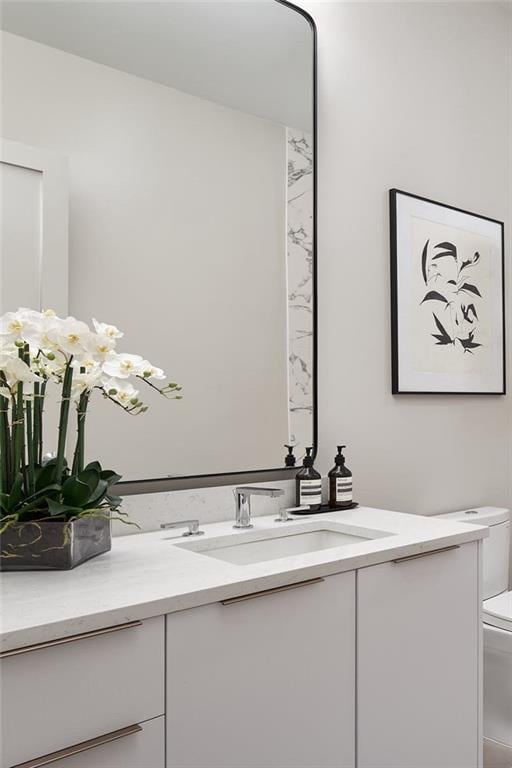 bathroom featuring toilet and vanity