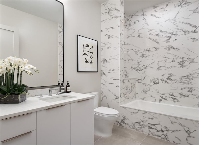 full bathroom with toilet, vanity, tiled shower / bath, and tile patterned flooring