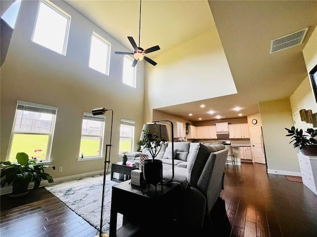 2579 Wimberley Pine Ct, Dacula, GA 30019 - living area with a high ceiling, dark wood-type flooring, a ceiling fan, baseboards, and plenty of natural light
