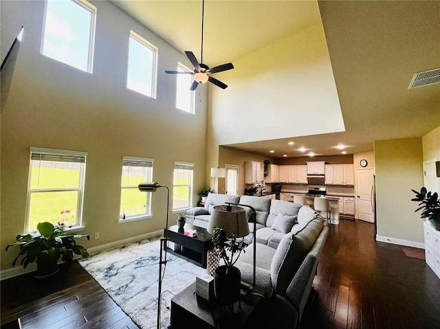 2579 Wimberley Pine Ct, Dacula, GA 30019 - living room featuring dark wood-style floors, a towering ceiling, baseboards, a ceiling fan, and recessed lighting