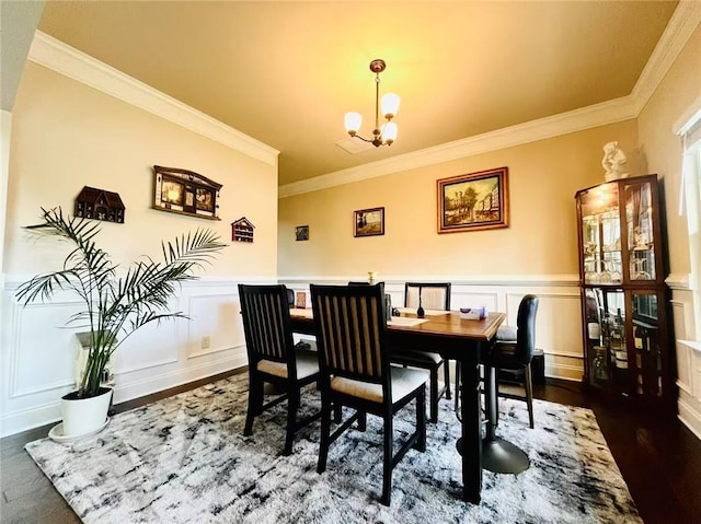 2579 Wimberley Pine Ct, Dacula, GA 30019 - dining space with ornamental molding, a chandelier, a decorative wall, dark wood-style floors, and wainscoting