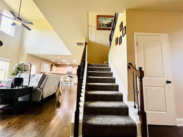 2579 Wimberley Pine Ct, Dacula, GA 30019 - stairway with a ceiling fan, wood-type flooring, and a high ceiling