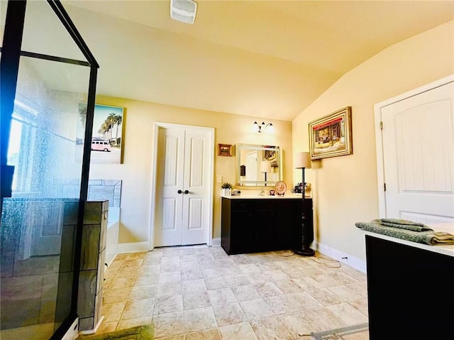 2579 Wimberley Pine Ct, Dacula, GA 30019 - full bathroom featuring a stall shower, vaulted ceiling, vanity, baseboards, and a bath