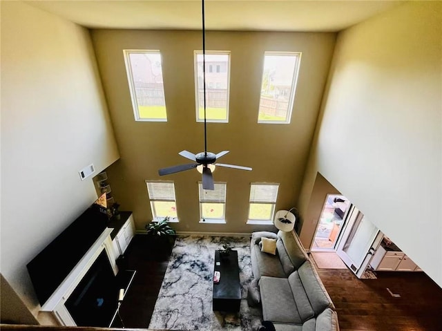 2579 Wimberley Pine Ct, Dacula, GA 30019 - living room with wood finished floors, a high ceiling, a ceiling fan, and baseboards